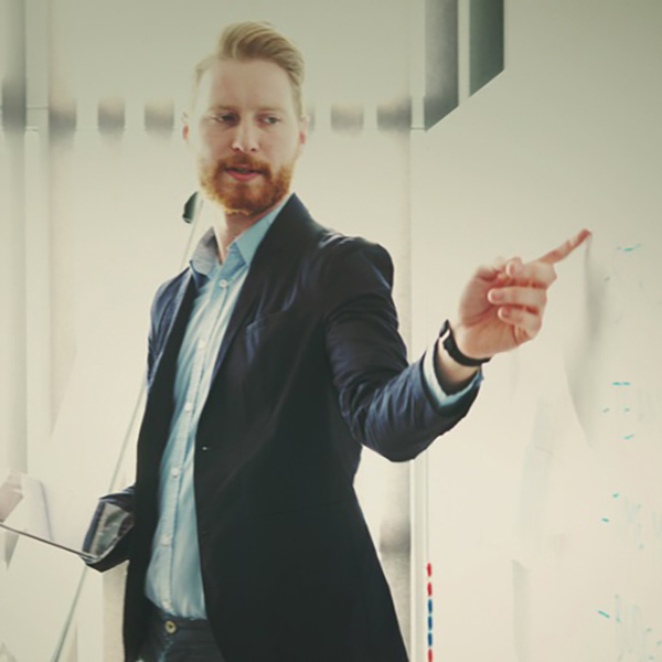man pointing at whiteboard