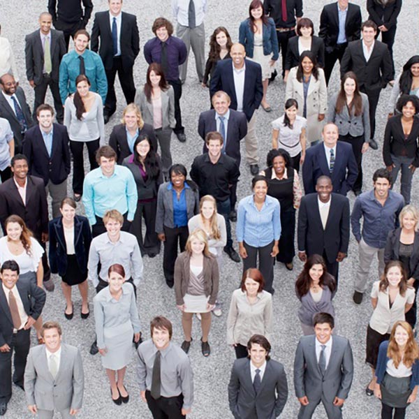 group of business professionals standing looking up at camera